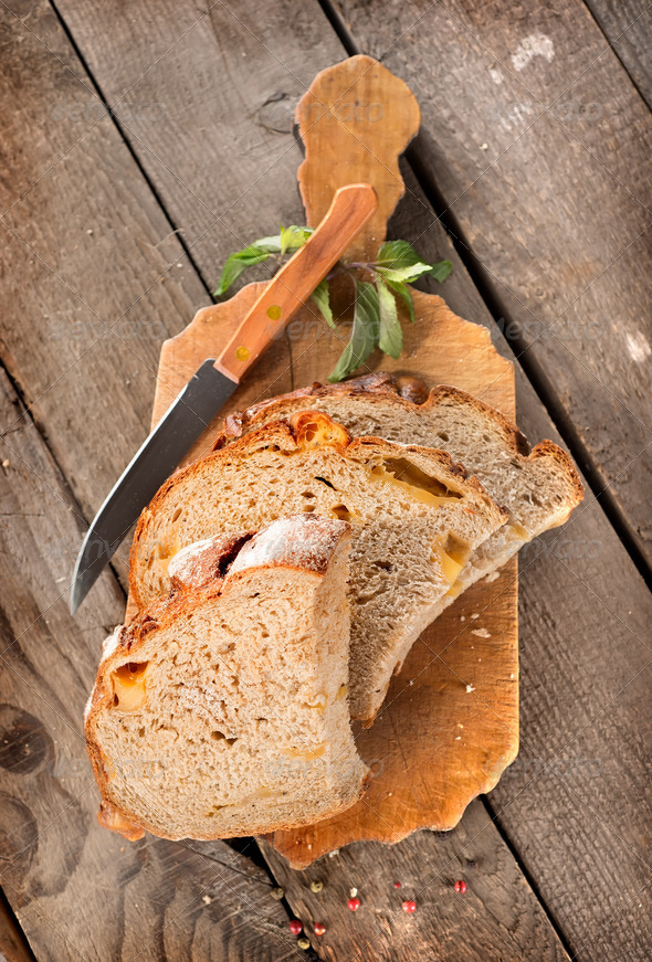 Bread with knife on a cutting board Stock Photo by Givaga PhotoDune
